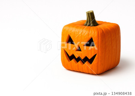 Square pumpkin with a carved face for Halloween. Space for text. 134908438