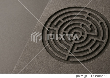 The circular labyrinth is carved into the stone surface. Space for text. 134908448