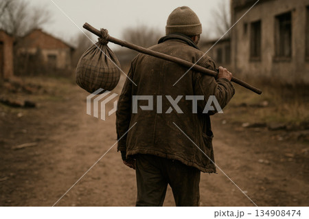 An old man walks along the road with a bag on a stick. An old man walks along the road with a bag on a stick. 134908474