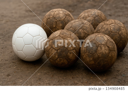 A white soccer ball among dirty balls. A white soccer ball among dirty balls. 134908485
