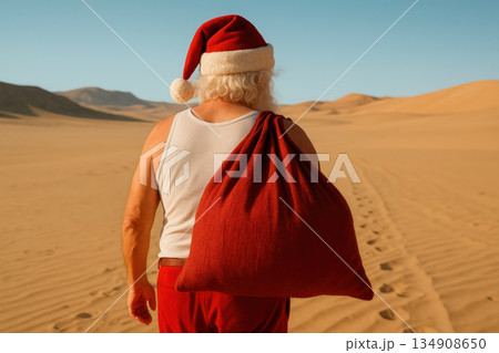 Santa Claus walks through the hot desert with a bag of gifts. Santa Claus walks through the hot desert with a bag of gifts. 134908650
