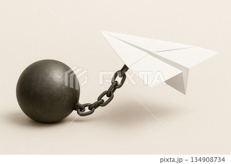 A paper plane chained with a heavy ball. Space for text. 134908734