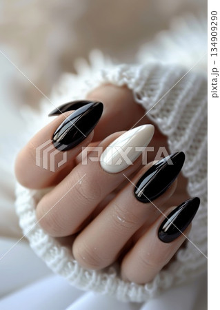 Closeup of black and white manicured nails with nail polish 134909290