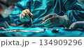 A surgeon in an electric blue operating room operates on a patient 134909296