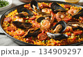 Seafood paella with shrimp, mussels, and chorizo on a table 134909297