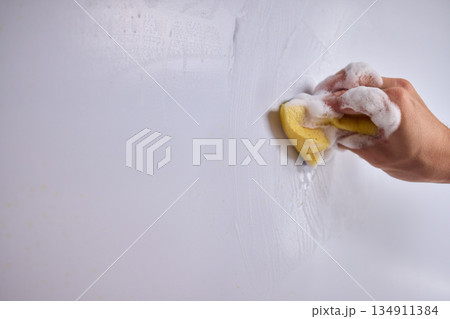 Cleaning the Kitchen Wall effectively with a Sponge and some good detergent for hygiene Cleaning the Kitchen Wall effectively with a Sponge and some good detergent for hygiene 134911384
