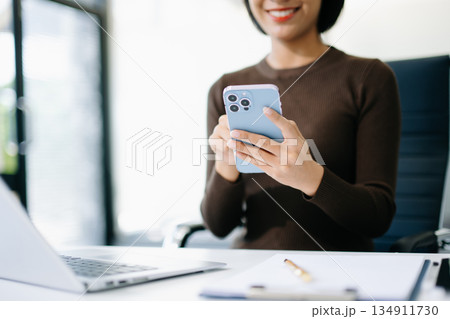 business documents on office table with smart phone and digital tablet and graph business with social network diagram and woman working in the office business documents on office table with smart phone and digital tablet and graph business with social network diagram and woman working in the office 134911730