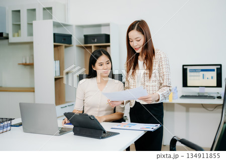 Business portrait two woman asian  smile cheerful talk and holding tablet, computer and hands up happy with in agreement ready new project 134911855