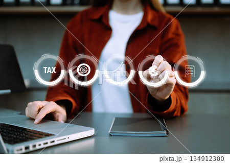 Busines using a computer to complete Individual income tax return form online for tax payment.Tax and Vat concept. 134912300