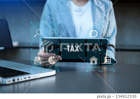 Busines using a computer to complete Individual income tax return form online for tax payment.Tax and Vat concept. 134912330