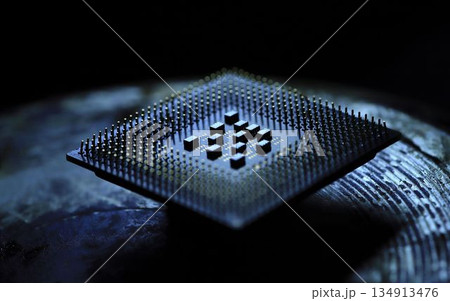 A detailed close-up of a computer microchip highlighting its intricate pins and circuits on a sleek metallic surface 134913476