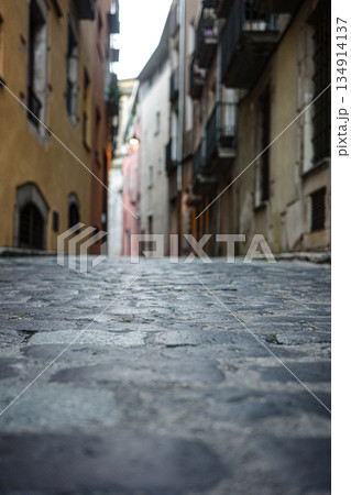 Low Angle View of Narrow Old Town Cobblestone Street 134914137