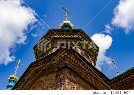 Ornate orthodox church dome cross under blue sky. Historic religious building Ornate orthodox church dome cross under blue sky. Historic religious building 134914604