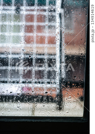 Rain Drops on Window with Blurred Urban Background Rain Drops on Window with Blurred Urban Background 134914619