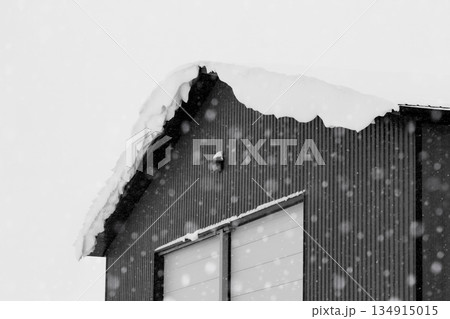 Industrial storage building covered with snow after snowfall. 134915015
