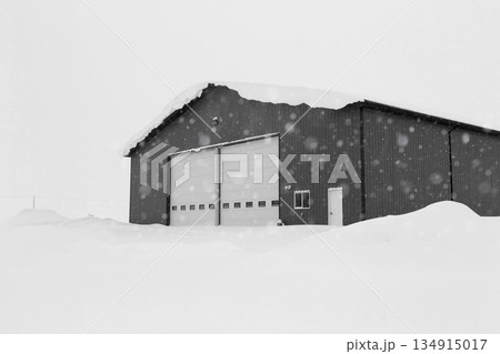 Industrial storage building covered with snow after snowfall. 134915017