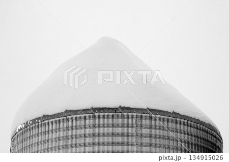 Monochrome of steel grain bins covered with snow after snowfall. 134915026