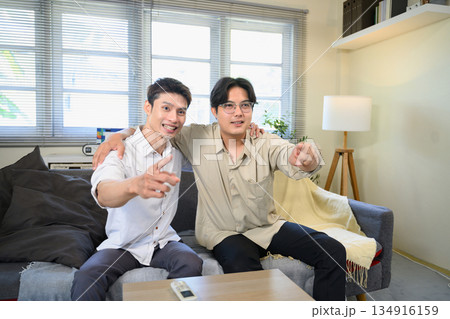 Photo Set Of Two Excited Male Friends Celebrate Watching Sports On Television At Home Photo Set Of Two Excited Male Friends Celebrate Watching Sports On Television At Home 134916159