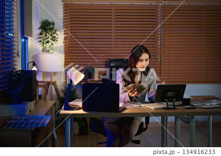 Women interior designer working in office at night Women interior designer working in office at night 134916233
