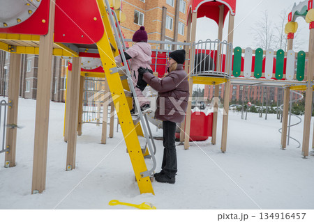 Child safety ensured, Protecting young children with guardianship on snowy outdoor conditions, Ensuring security and stability of children during winter outdoor adventures with guardianship 134916457