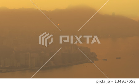 Hong Kong skyline glowing in warm golden light Dec 28 2025 134917058