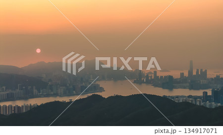 Hong Kong skyline glowing in warm golden light Dec 28 2021 134917071