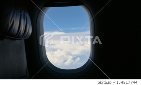 Scenery outside the window of a passenger plane, beautiful blue sky and white cloud view Scenery outside the window of a passenger plane, beautiful blue sky and white cloud view 134917744