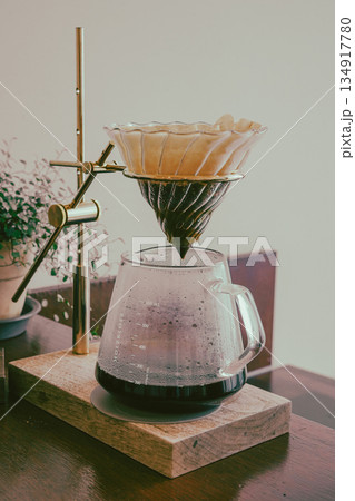 Hand Drip Coffee Extracting into Glass Server Hand Drip Coffee Extracting into Glass Server 134917780