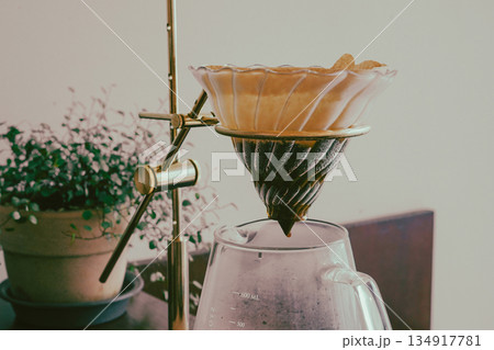 Coffee Dripping Through Paper Filter 134917781