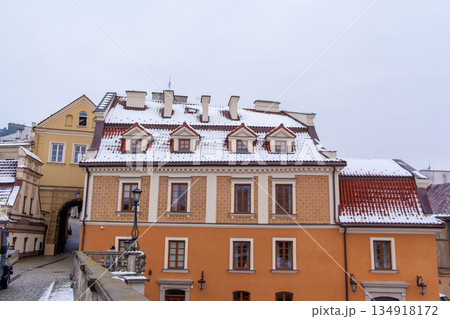 Historic building with snow on the roof in a city square during winter 134918172