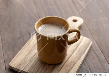 冬の午後のティータイムに楽しむ温かいカフェラテと木のぬくもり 134919194
