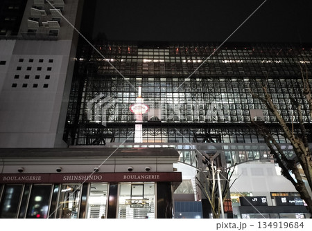 夜のJR京都駅の駅ビルに映り込んだ京都タワー 134919684