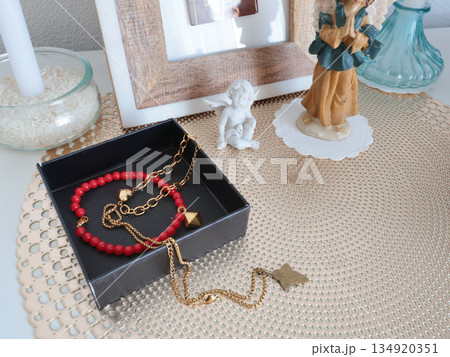 Christian corner at home. Icons and candles. Angel figurine and bracelet. Faith, symbols, and traditions. Christian corner at home. Icons and candles. Angel figurine and bracelet. Faith, symbols, and traditions. 134920351