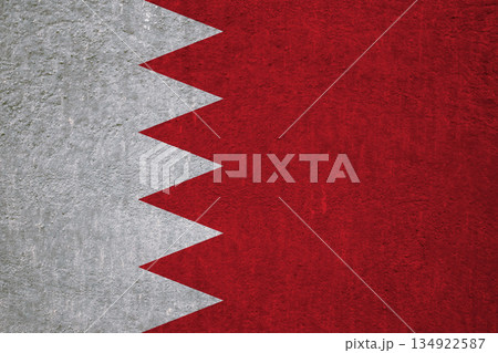 Flag of Bahrain on an ancient concrete surface. Concept of Bahraini heritage and patriotism.. Flag of Bahrain on an ancient concrete surface. Concept of Bahraini heritage and patriotism.. 134922587