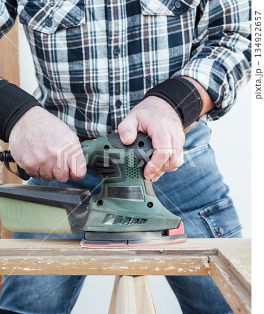 Carpenter at work, restoring an old wooden window. Carpentry. Carpenter at work, restoring an old wooden window. Carpentry. 134922657