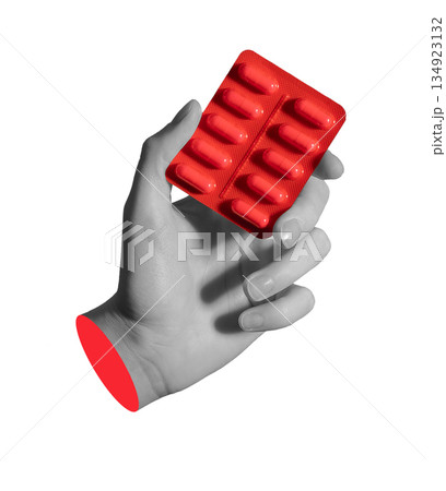 Hand holding a red blister pack of pills, symbolizing prescription drugs and modern treatment. 134923132