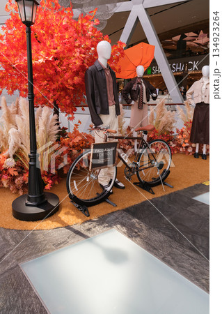 Autumn display with bicycle and mannequins at Changi Airport in Singapore Autumn display with bicycle and mannequins at Changi Airport in Singapore 134923264