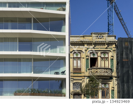Contrast of architecture in Porto, Portugal, showing an ornate historic building with decorative 134923469