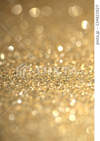 Gold shimmer glitter background with focus and bokeh Gold shimmer glitter background with focus and bokeh 134923827