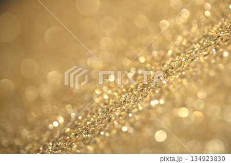 Gold shimmer glitter background with focus and bokeh Gold shimmer glitter background with focus and bokeh 134923830