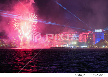 Thessaloniki, Greece NYE Fireworks and Laser Beams Over Seafront Skyline. Thessaloniki, Greece NYE Fireworks and Laser Beams Over Seafront Skyline. 134923846