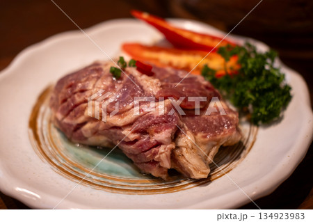 Raw marinated pork collar on the plate 134923983
