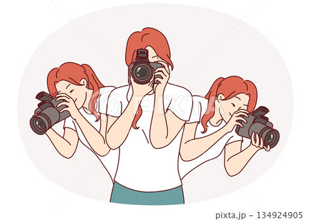 Woman photographer holds camera to create photo reports and looks in different directions 134924905