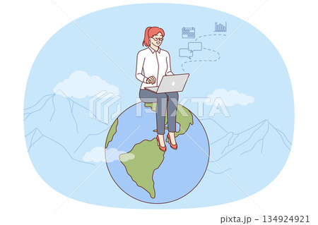 Woman freelancer works for international company via internet, sits on globe with laptop on lap 134924921