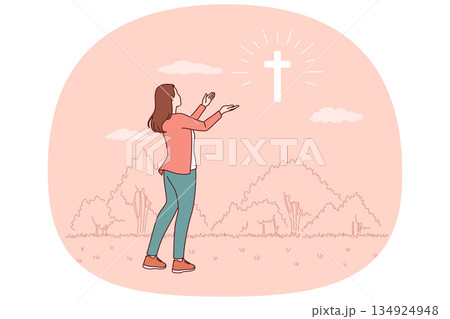 Catholic woman looks at cross glowing in sky, praying to god for help in finding right path Catholic woman looks at cross glowing in sky, praying to god for help in finding right path 134924948