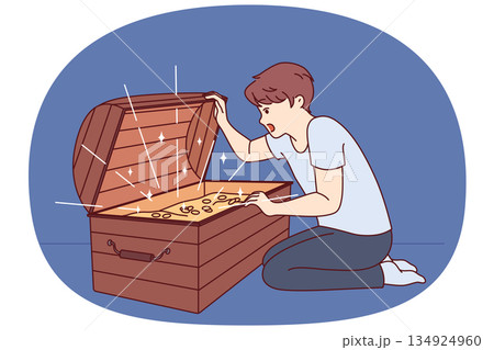 Little boy has found treasure with gold coins and joyfully opens mouth seeing contents of chest Little boy has found treasure with gold coins and joyfully opens mouth seeing contents of chest 134924960