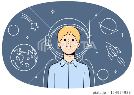 Boy astronaut in imaginary suit and spacesuit for space flights stands among stars and planets 134924988