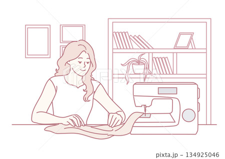 Happy woman sewing on machine at home 134925046