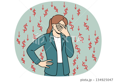 Businesswoman who is victim of financial crisis covers eyes with hand, standing among dollar signs 134925047