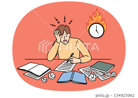 Excited man student is writing thesis and panicking because of deadline, sitting near burning clock 134925062
